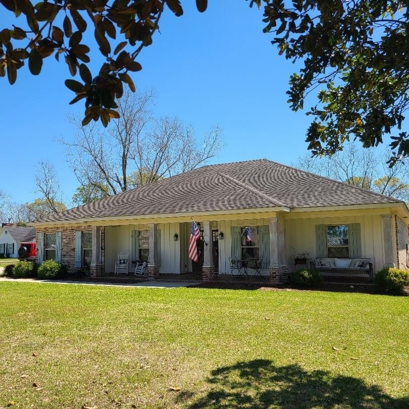 10051 Blackwell Nursery Road Semmes, AL 36575 - Photo 4 of 54 View of front of property with a porch, board and batten siding, and a front lawn