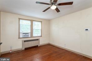 1618 Roundhill Road Baltimore, MD 21218 - Photo 18 of 47 an empty room with a window and a fan