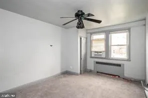 a view of room with a ceiling fan and window