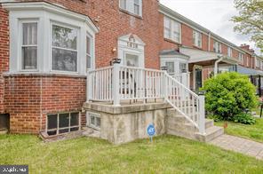 1618 Roundhill Road Baltimore, MD 21218 - Photo 39 of 47 a view of a house with a small yard and flower plants