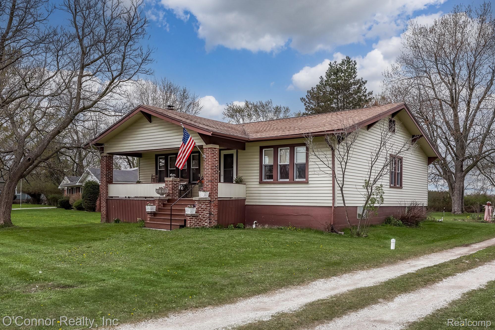 3323 Kinney Road Emmett, MI 48022 - Photo 1 of 29 Ranch-style residence featuring light-colored siding and a contrasting brown roof