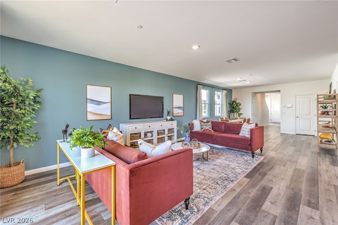 1017 Copper Robin Street Henderson, NV 89011 - Photo 11 of 43 Living area featuring baseboards, wood finished floors, and recessed lighting. Photo is representational only; actual home finishes may vary.