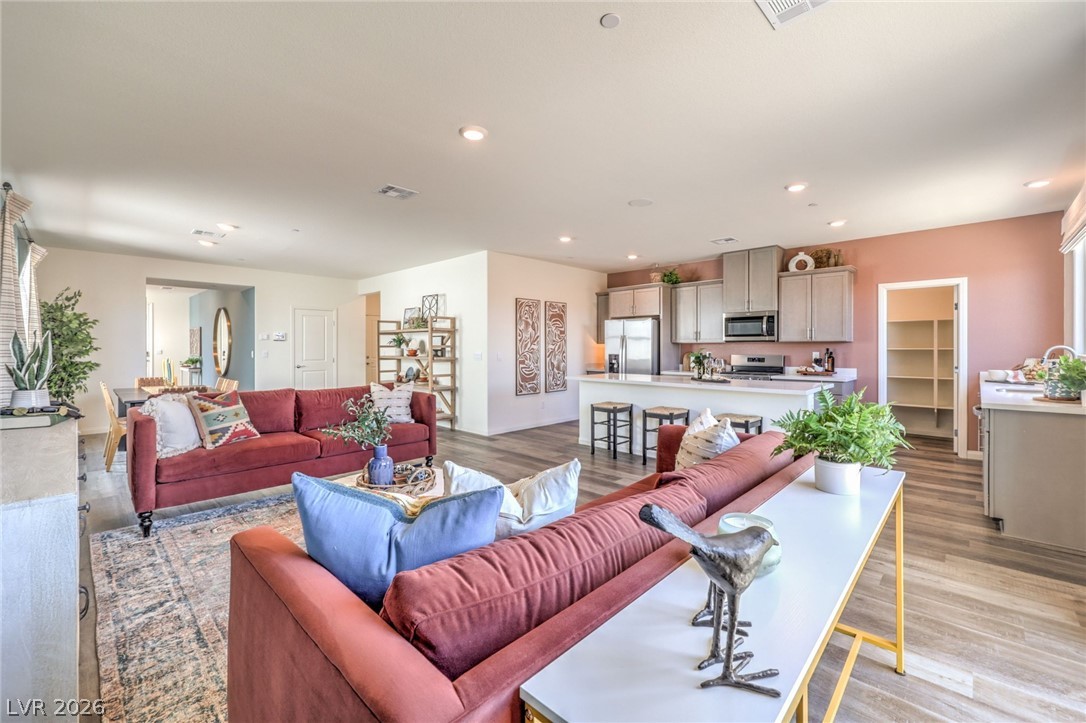 1017 Copper Robin Street Henderson, NV 89011 - Photo 12 of 43 Living room with light wood-style flooring and recessed lighting. Photo is representational only; actual home finishes may vary.
