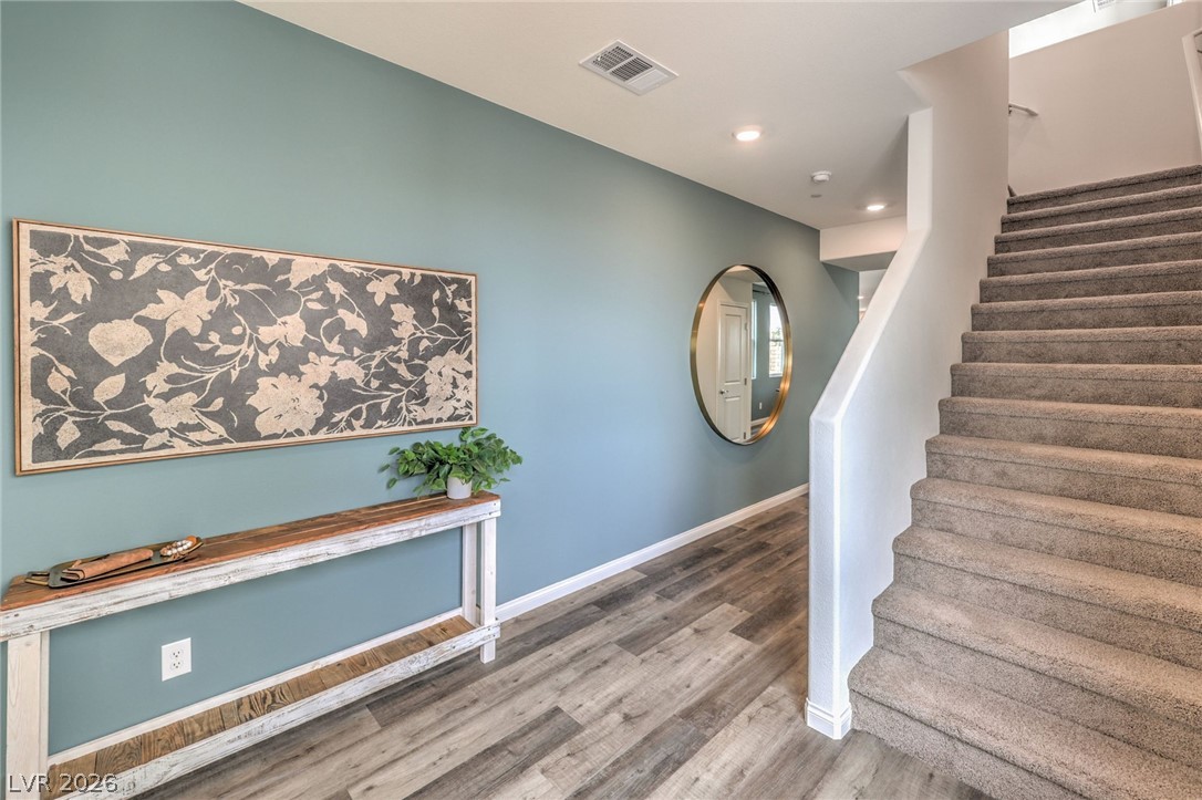 1017 Copper Robin Street Henderson, NV 89011 - Photo 15 of 43 Stairway with wood finished floors, baseboards, and recessed lighting. Photo is representational only; actual home finishes may vary.