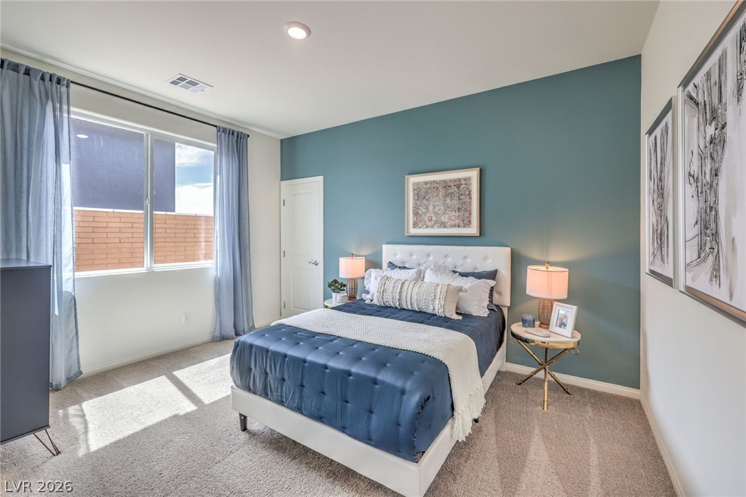 1017 Copper Robin Street Henderson, NV 89011 - Photo 16 of 43 Bedroom on the first floor. Photo is representational only; actual home finishes may vary. Bedroom on the first floor with carpet floors and baseboards