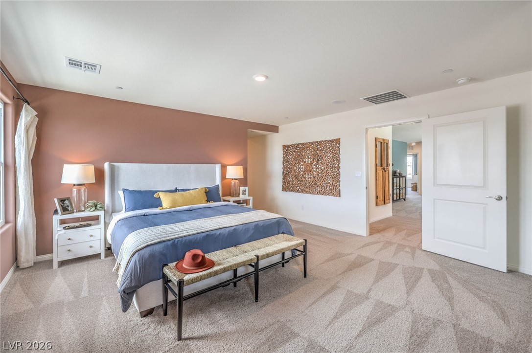 1017 Copper Robin Street Henderson, NV 89011 - Photo 19 of 43 Bedroom featuring carpet and multiple windows. Photo is representational only; actual home finishes may vary.