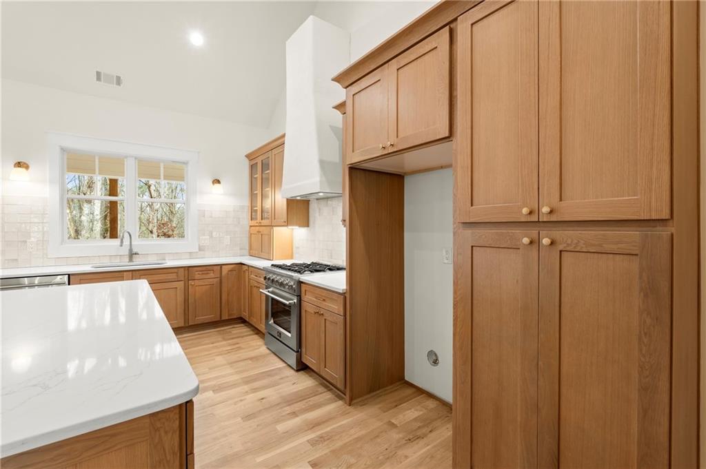 2020 Darby Road Waleska, GA 30183 - Photo 12 of 49 a kitchen with stainless steel appliances granite countertop a refrigerator a stove and a sink with wooden cabinets
