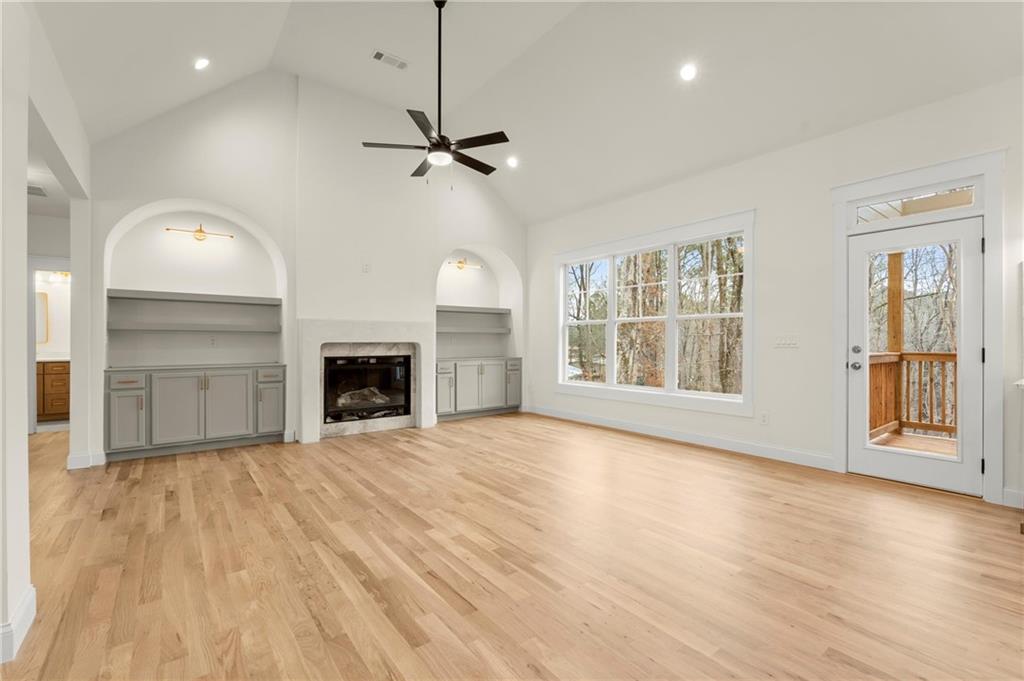 2020 Darby Road Waleska, GA 30183 - Photo 15 of 49 an empty room with wooden floor fireplace and windows