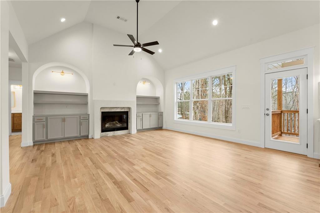 2020 Darby Road Waleska, GA 30183 - Photo 16 of 49 an empty room with wooden floor fireplace and windows