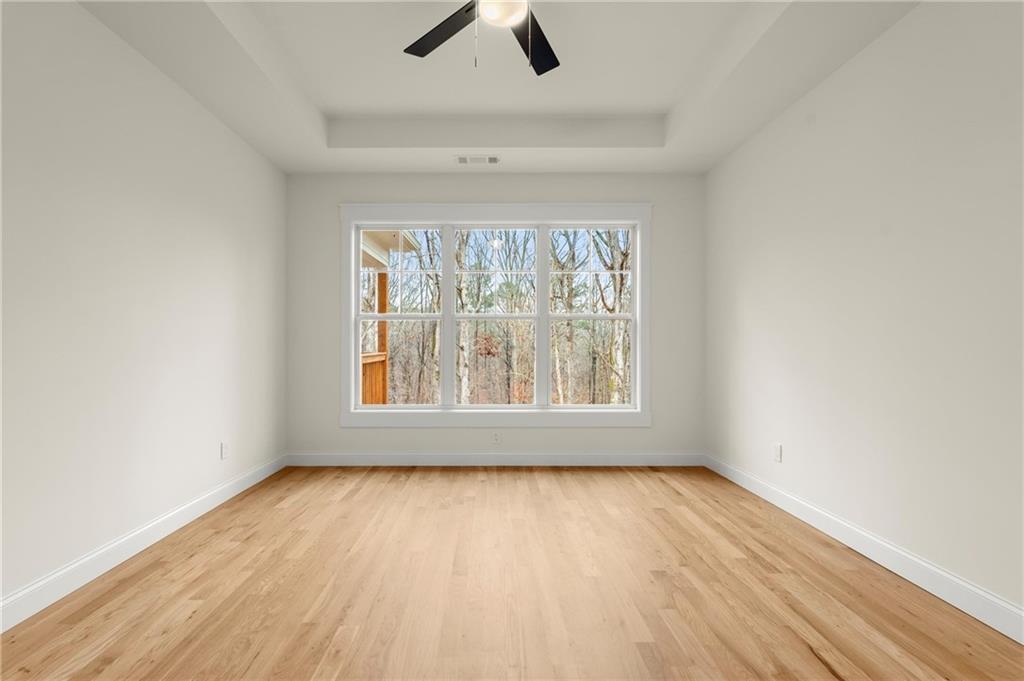 2020 Darby Road Waleska, GA 30183 - Photo 23 of 49 an empty room with a window and wooden floor