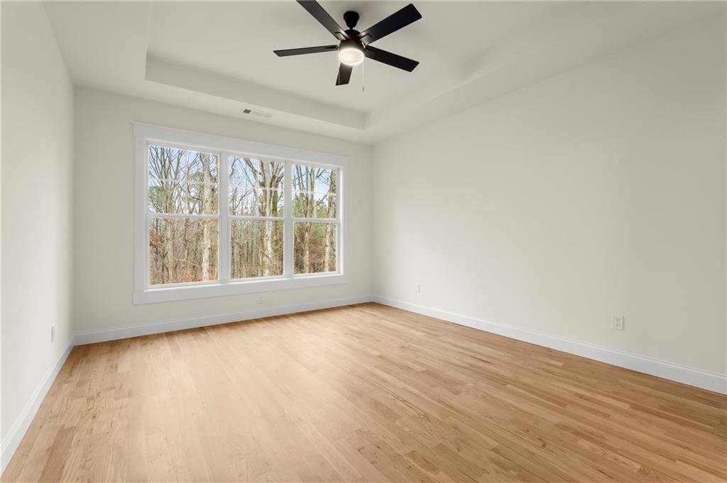 2020 Darby Road Waleska, GA 30183 - Photo 24 of 49 an empty room with wooden floor fan and windows