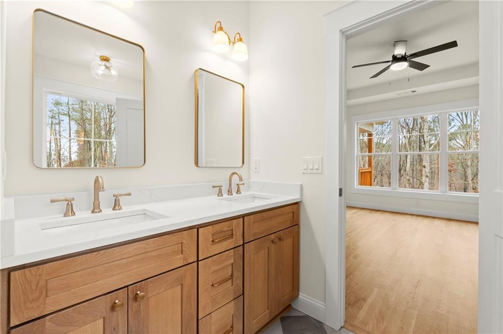 2020 Darby Road Waleska, GA 30183 - Photo 30 of 49 a bathroom with a double vanity sink and mirror with window