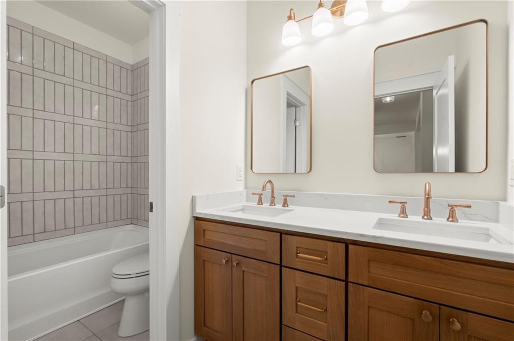 2020 Darby Road Waleska, GA 30183 - Photo 37 of 49 a bathroom with a toilet a sink a bathtub and a mirror