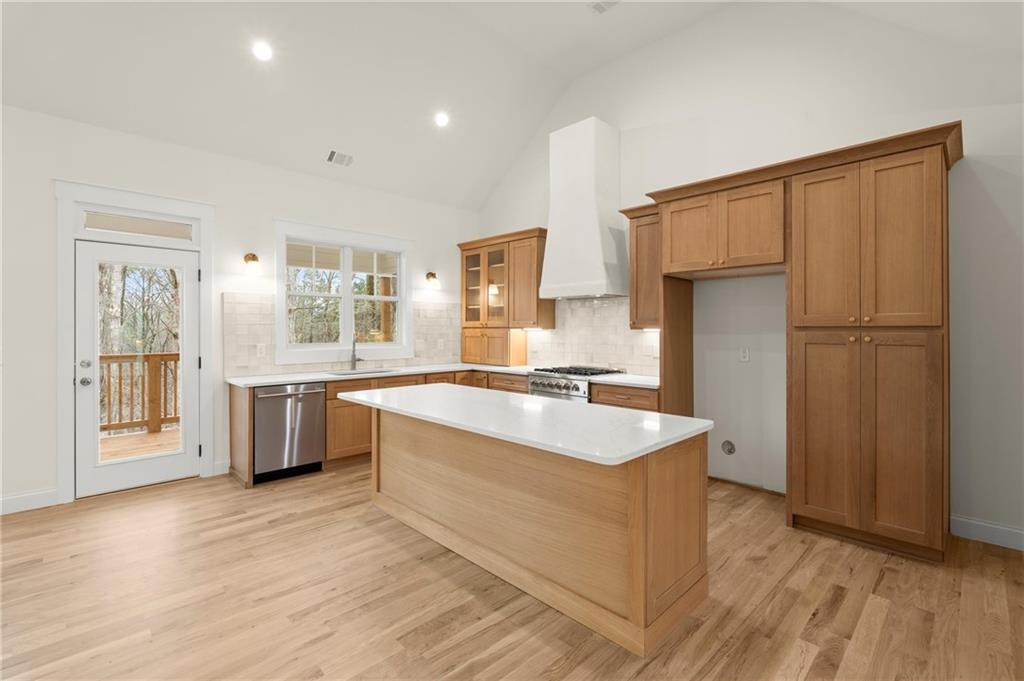 2020 Darby Road Waleska, GA 30183 - Photo 9 of 49 a large kitchen with kitchen island a sink a refrigerator a stove and a wooden floors