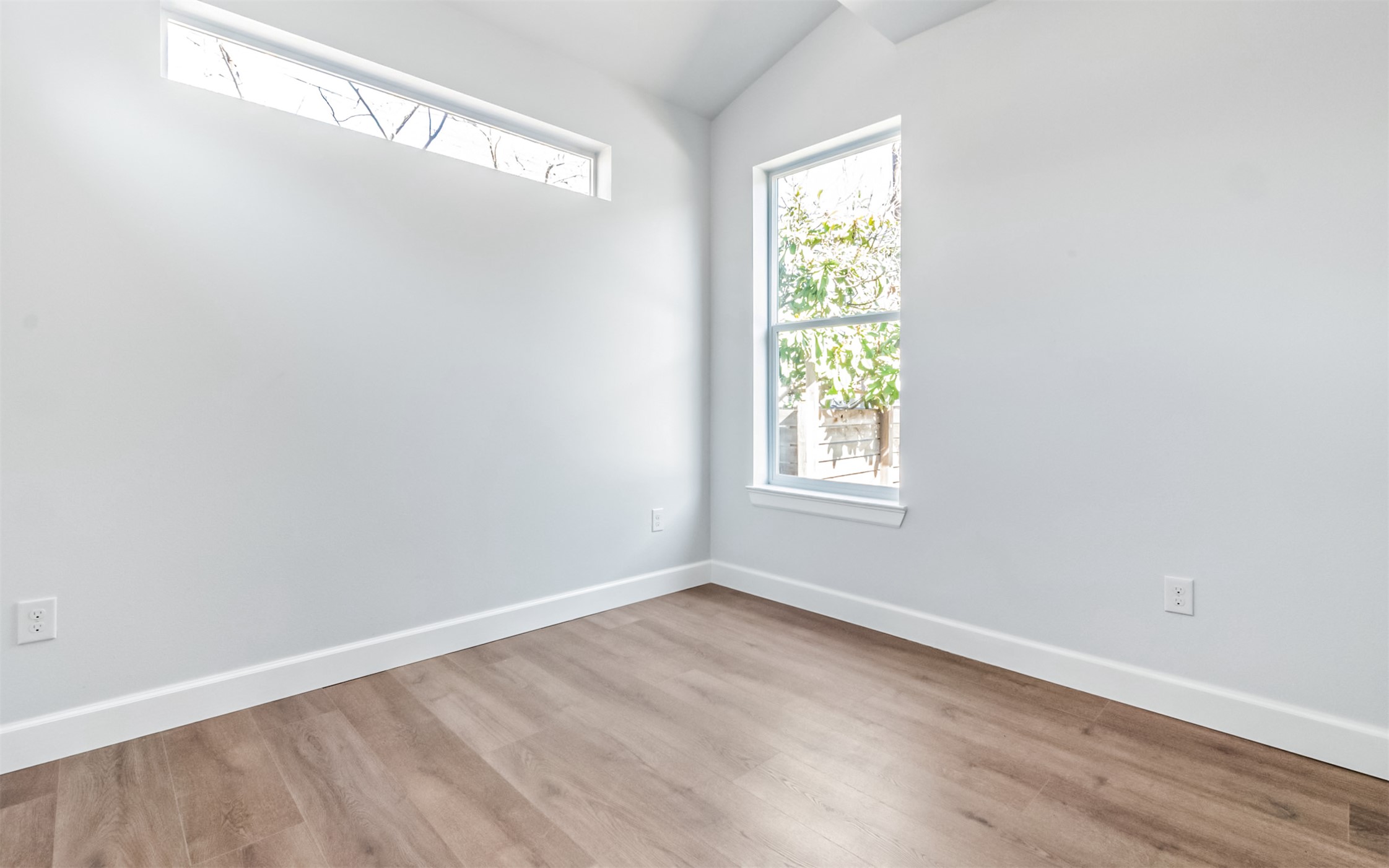 1130 Spur Street, Unit A Austin, TX 78721 - Photo 22 of 31 Unfurnished 3rd Bedroom featuring ceiling fan and vaulted ceiling (virtually staged)
