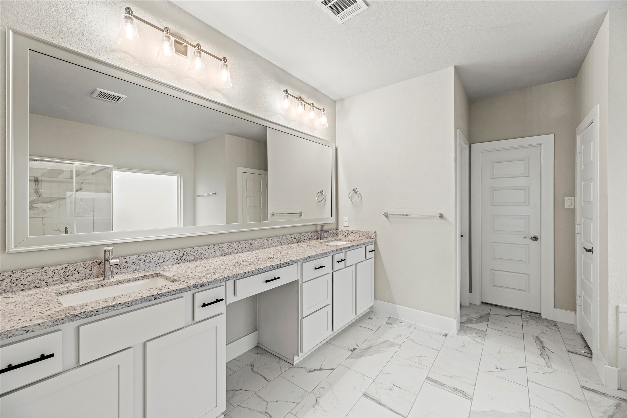 1600 Del Sol Rdg Lane Katy, TX 77493 - Photo 10 of 28 This private bath includes dual vanities with granite countertops and ample storage, creating a comfortable setup for daily routines.
