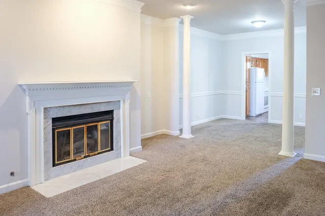 a view of an empty room with a fireplace