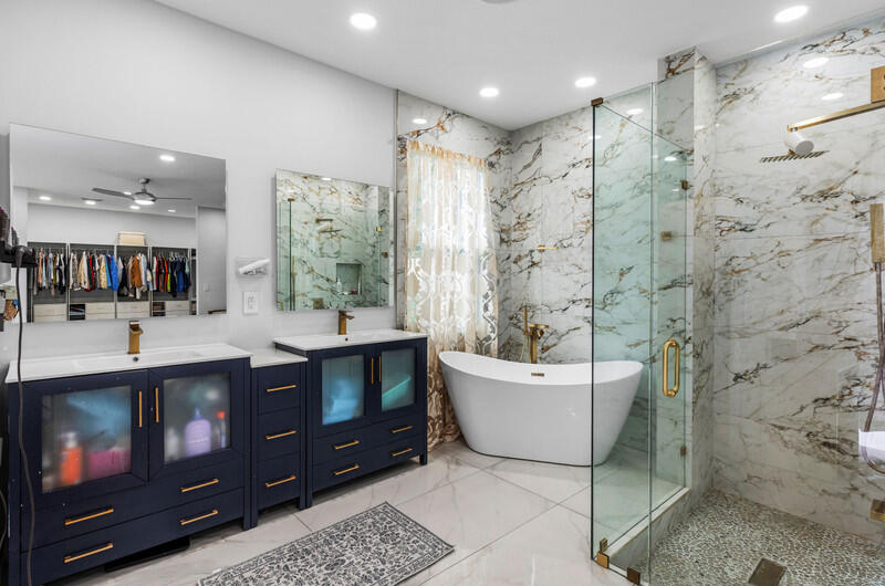 7748 Travelers Tree Drive Boca Raton, FL 33433 - Photo 11 of 31 a bathroom with a bathtub sink mirror and toilet
