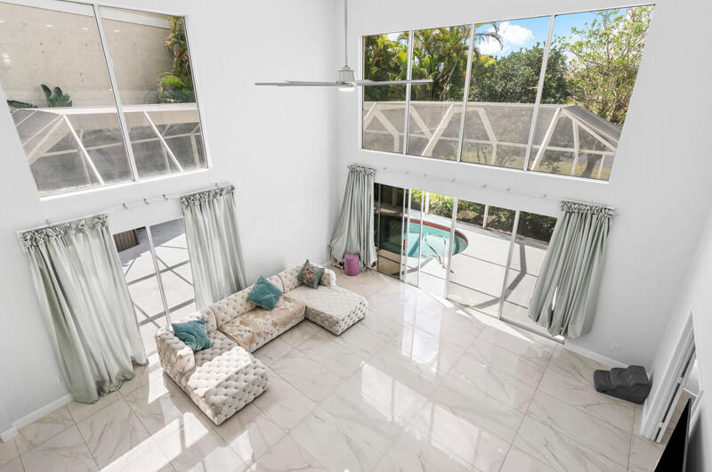 7748 Travelers Tree Drive Boca Raton, FL 33433 - Photo 18 of 31 a view of a living room with a floor to ceiling window and wooden floor
