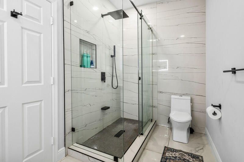 7748 Travelers Tree Drive Boca Raton, FL 33433 - Photo 23 of 31 a bathroom with a shower and a toilet