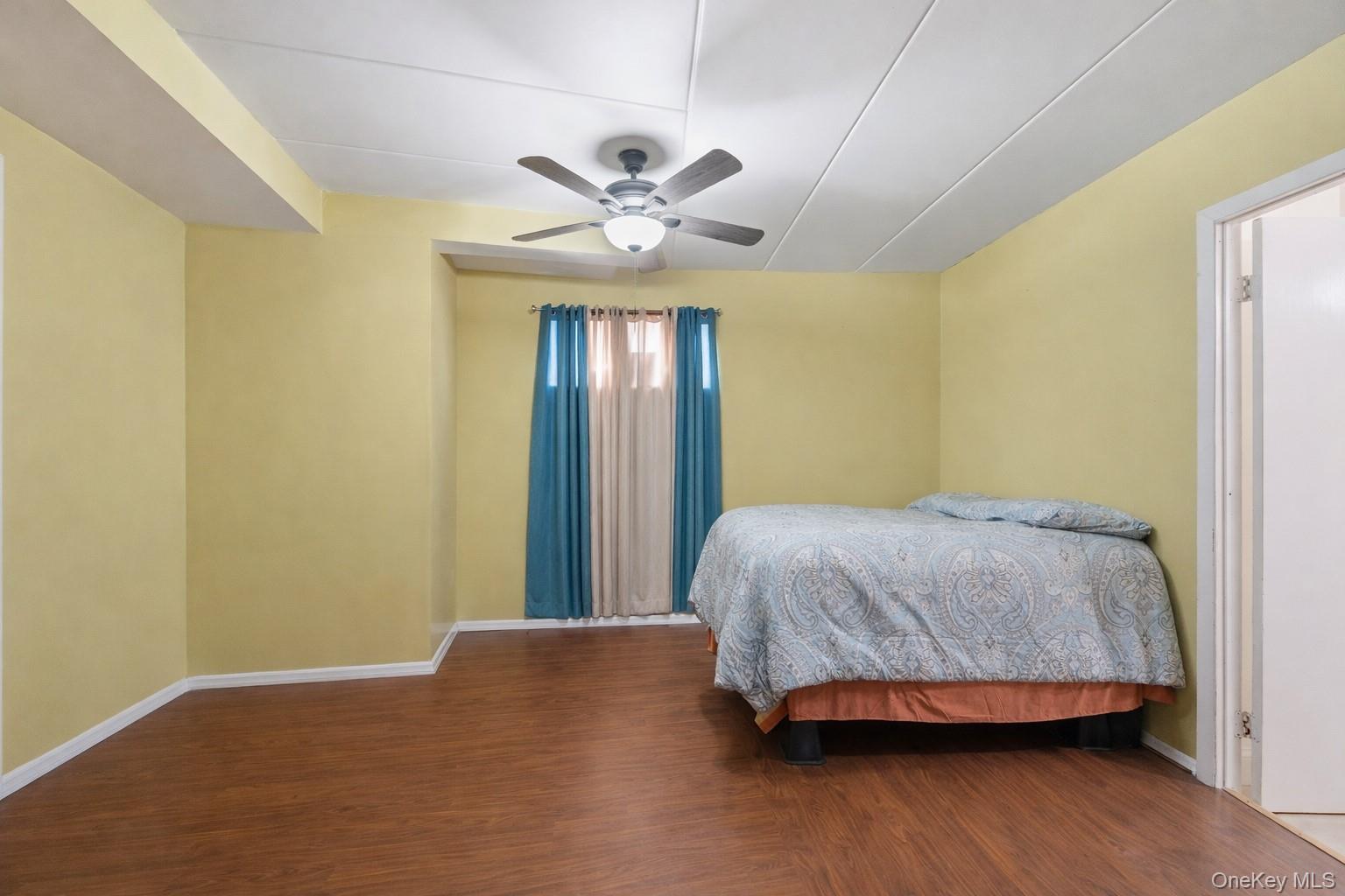 863 Home Street Bronx, NY 10459 - Photo 15 of 46 a bedroom with a bed and a chandelier