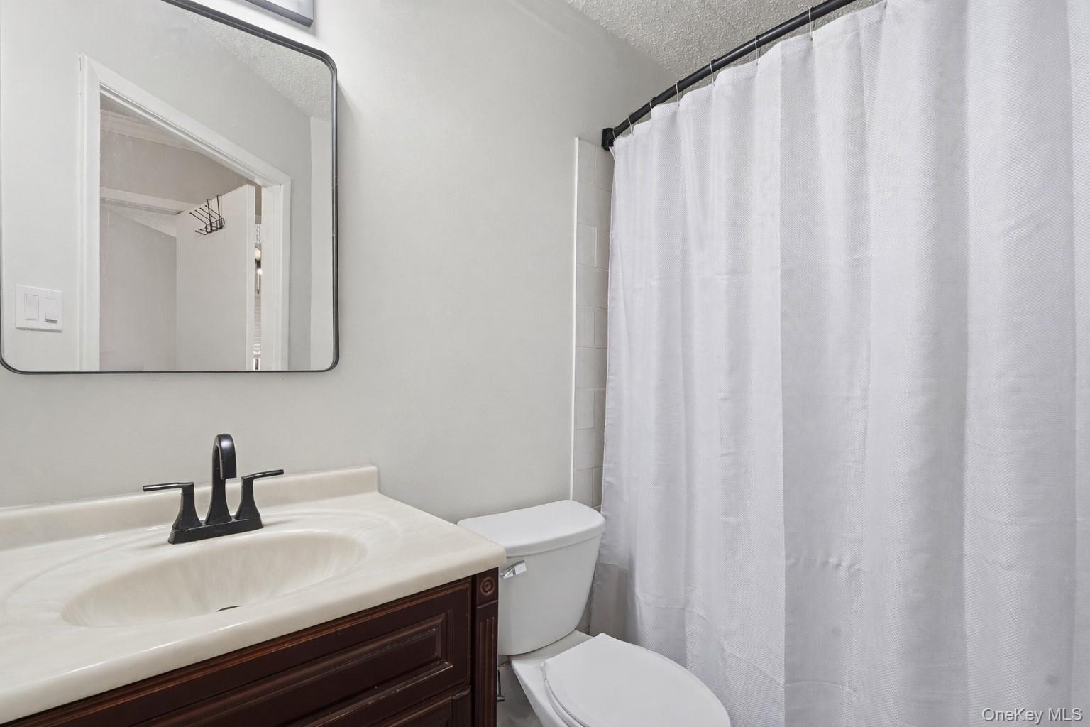 863 Home Street Bronx, NY 10459 - Photo 21 of 46 a bathroom with a sink toilet and mirror