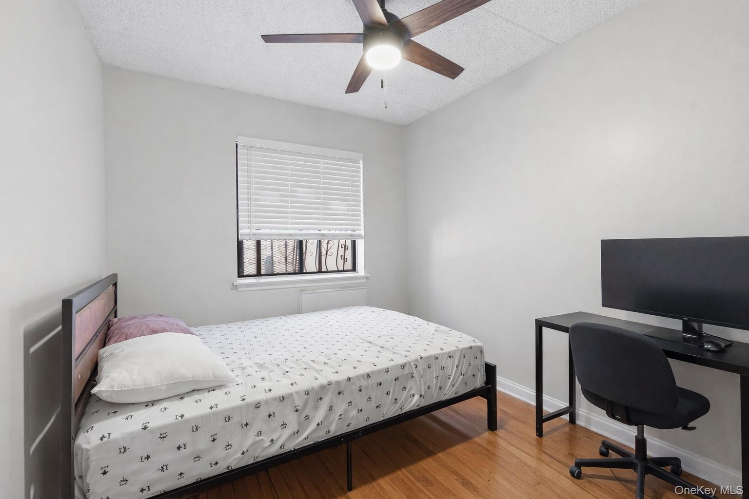 863 Home Street Bronx, NY 10459 - Photo 24 of 46 a bedroom with a bed and a flat screen tv