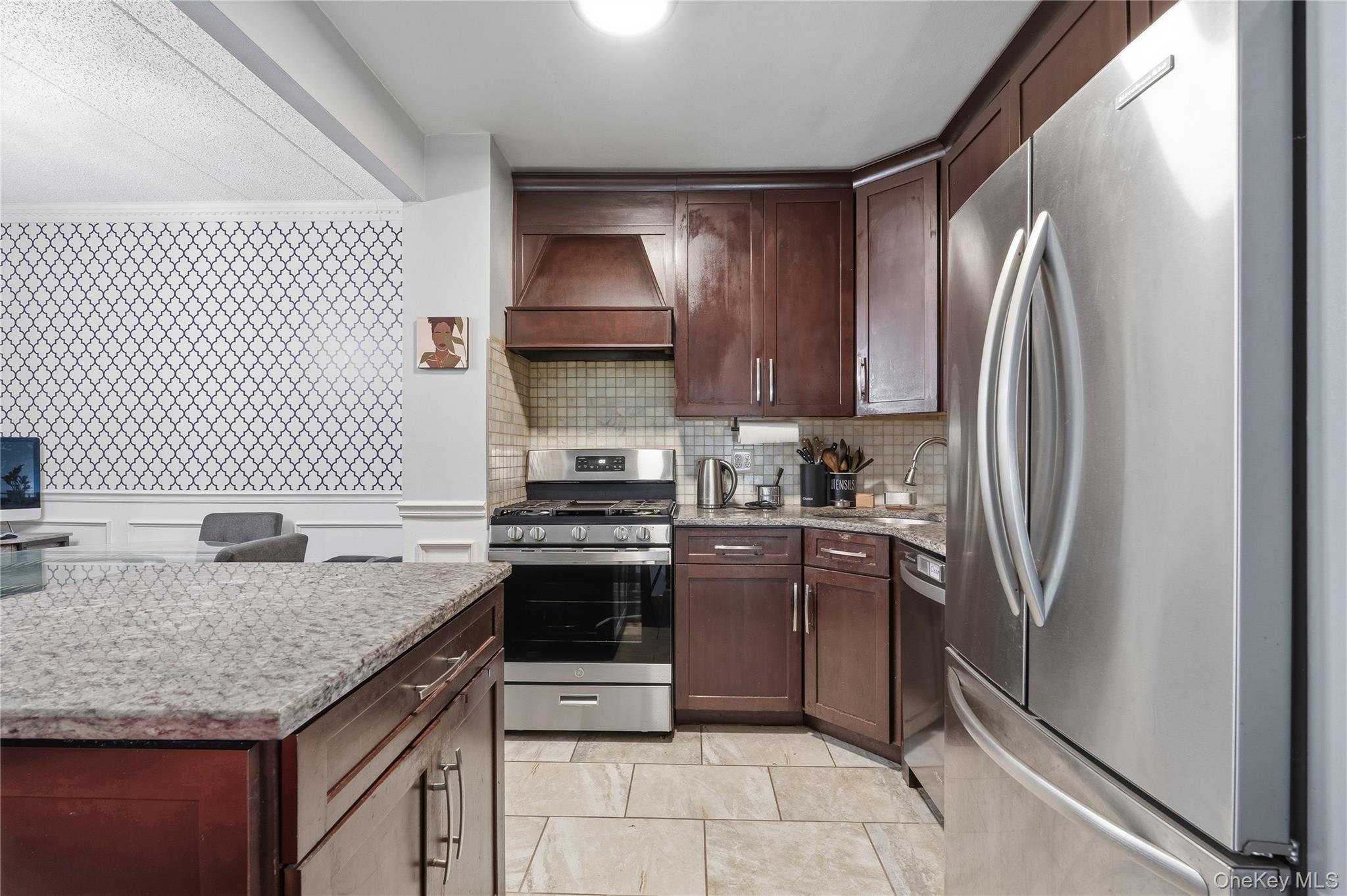 863 Home Street Bronx, NY 10459 - Photo 31 of 46 a kitchen with stainless steel appliances granite countertop a sink stove and refrigerator