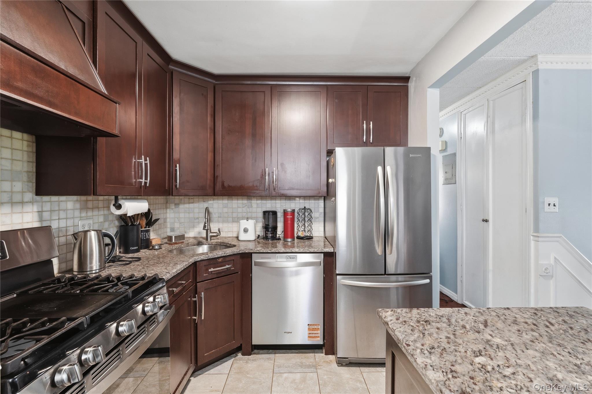 863 Home Street Bronx, NY 10459 - Photo 32 of 46 a kitchen with stainless steel appliances granite countertop a stove refrigerator sink and cabinets