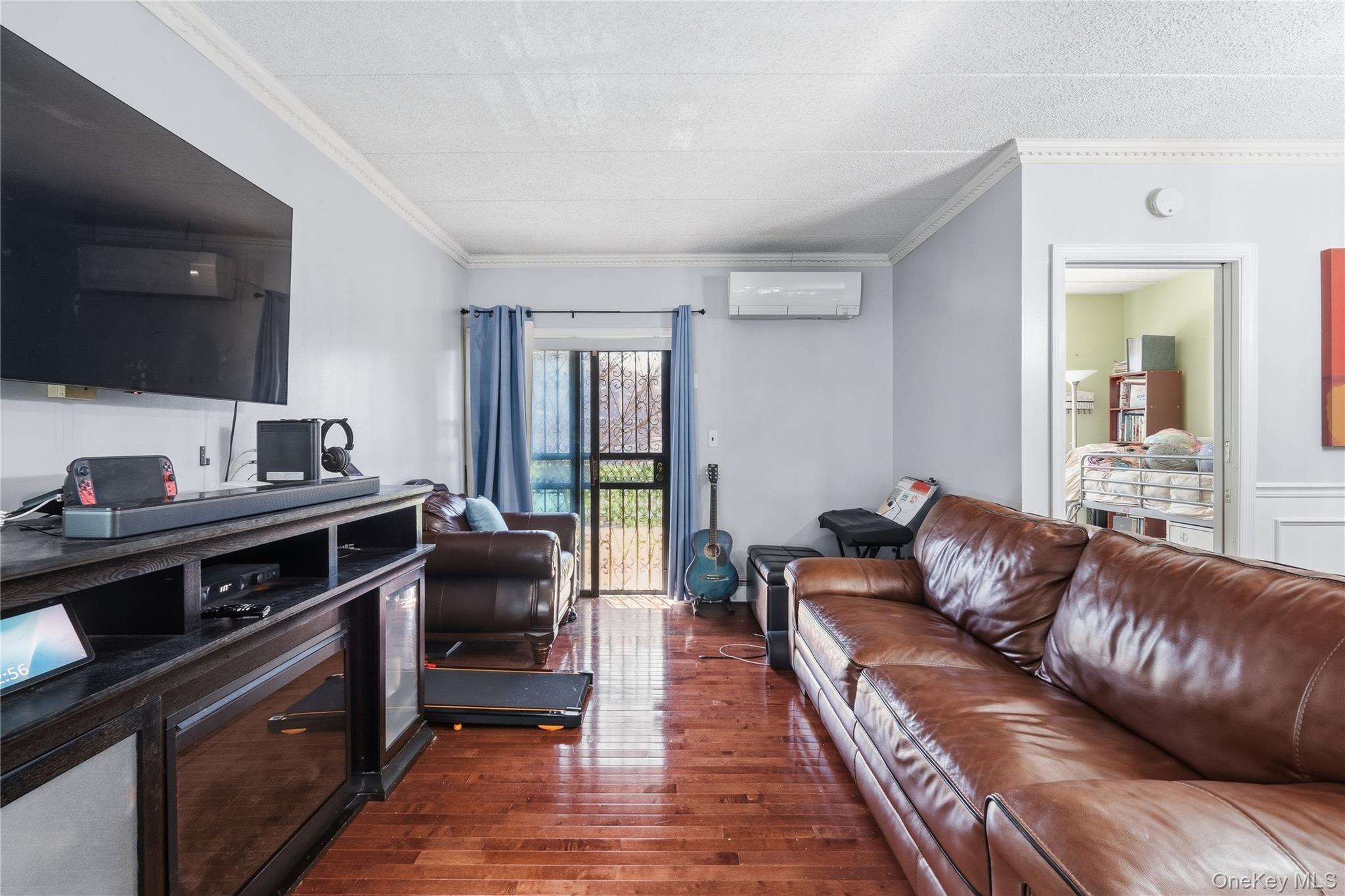 863 Home Street Bronx, NY 10459 - Photo 33 of 46 a living room with a couch and a wooden floor
