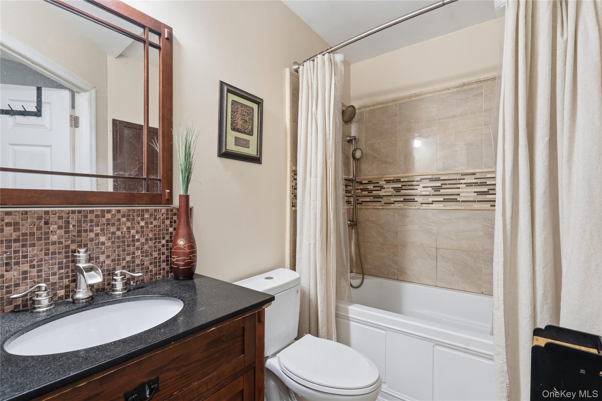863 Home Street Bronx, NY 10459 - Photo 37 of 46 a bathroom with a sink a toilet and shower