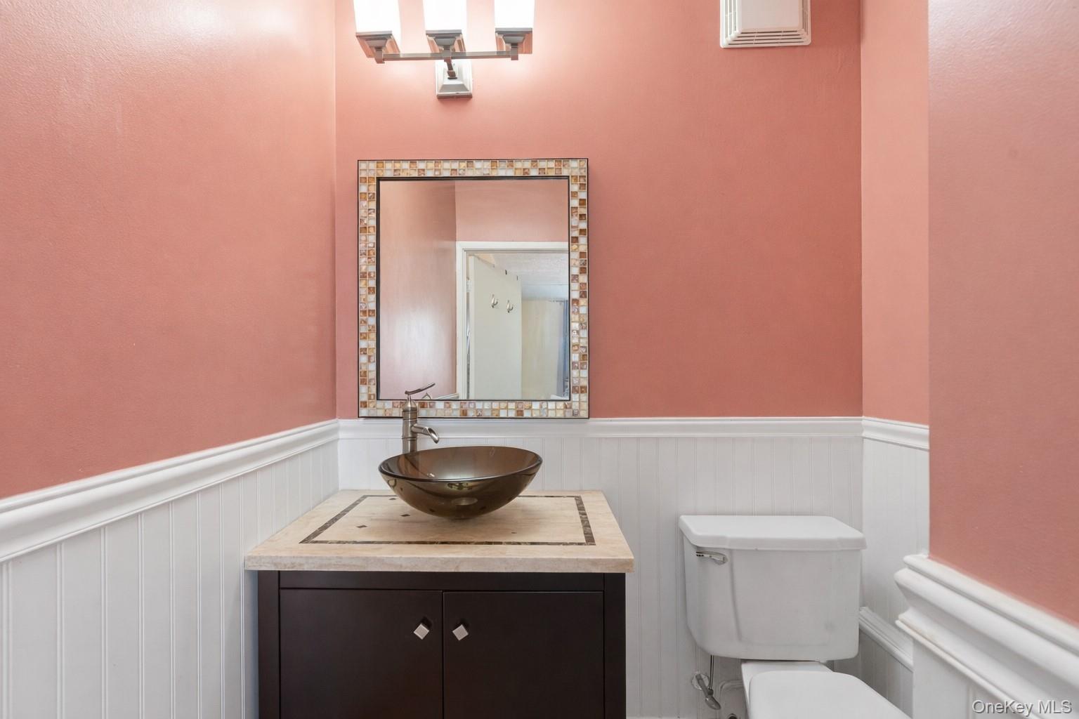 863 Home Street Bronx, NY 10459 - Photo 38 of 46 a bathroom with a toilet a sink and mirror