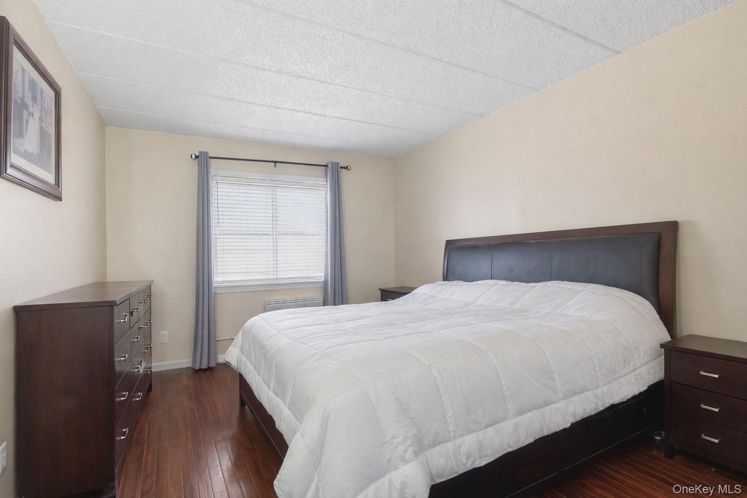 863 Home Street Bronx, NY 10459 - Photo 39 of 46 a bedroom with a bed and wooden floor