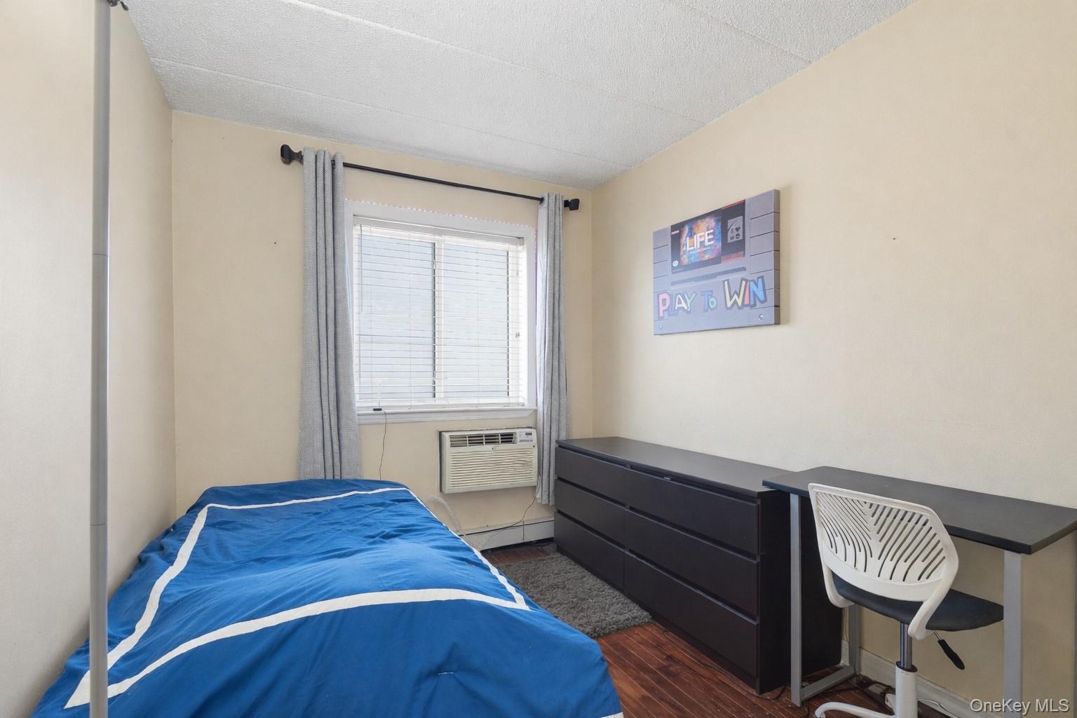 863 Home Street Bronx, NY 10459 - Photo 42 of 46 a bedroom with a bed and a window