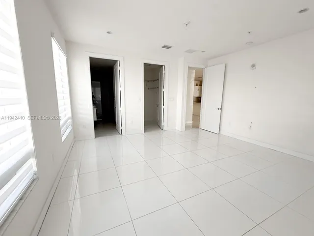 a view of a livingroom with an empty space and a window