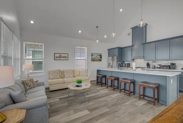 a living room with furniture a dining table and kitchen view