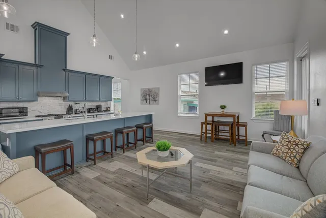 a work room with furniture wooden floor and a flat screen tv
