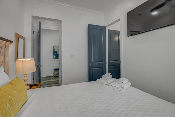 a bedroom with a bed and a chandelier