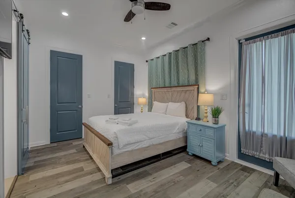 a bedroom with a bed and a chandelier