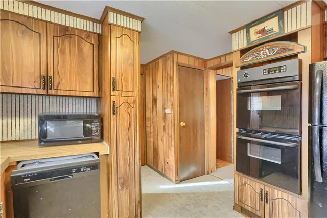 a kitchen with stainless steel appliances granite countertop a stove and a microwave