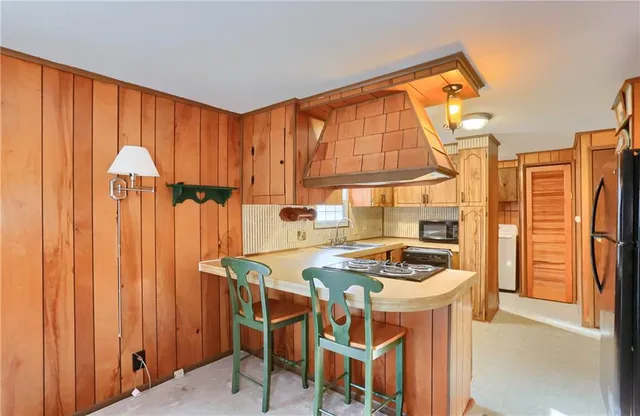 a kitchen that has a table and chairs in it