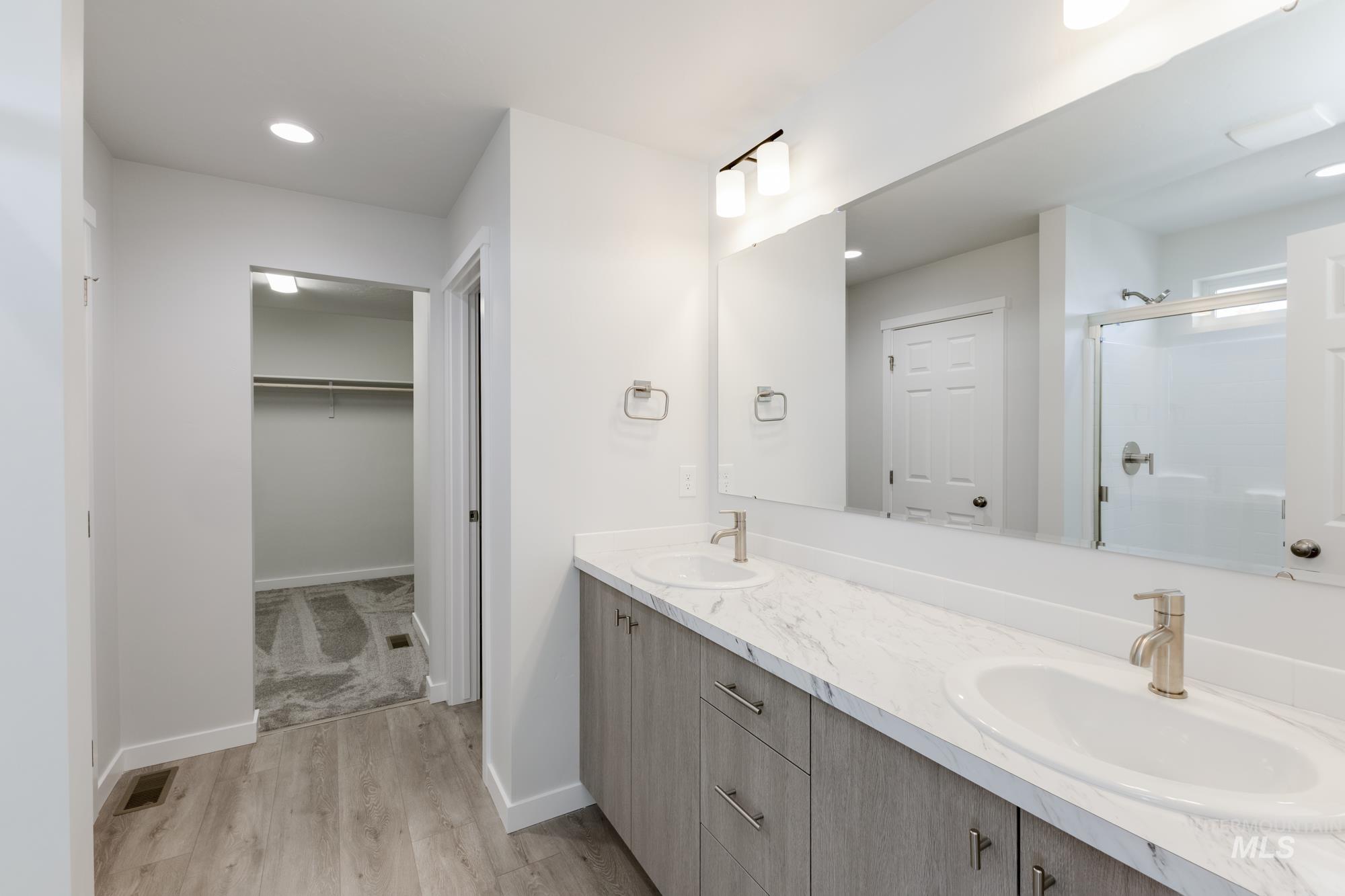 1107 Webb Brk Street Middleton, ID 83644 - Photo 22 of 23 Full bath with double vanity, light wood-style floors, a spacious closet, a stall shower, and recessed lighting
