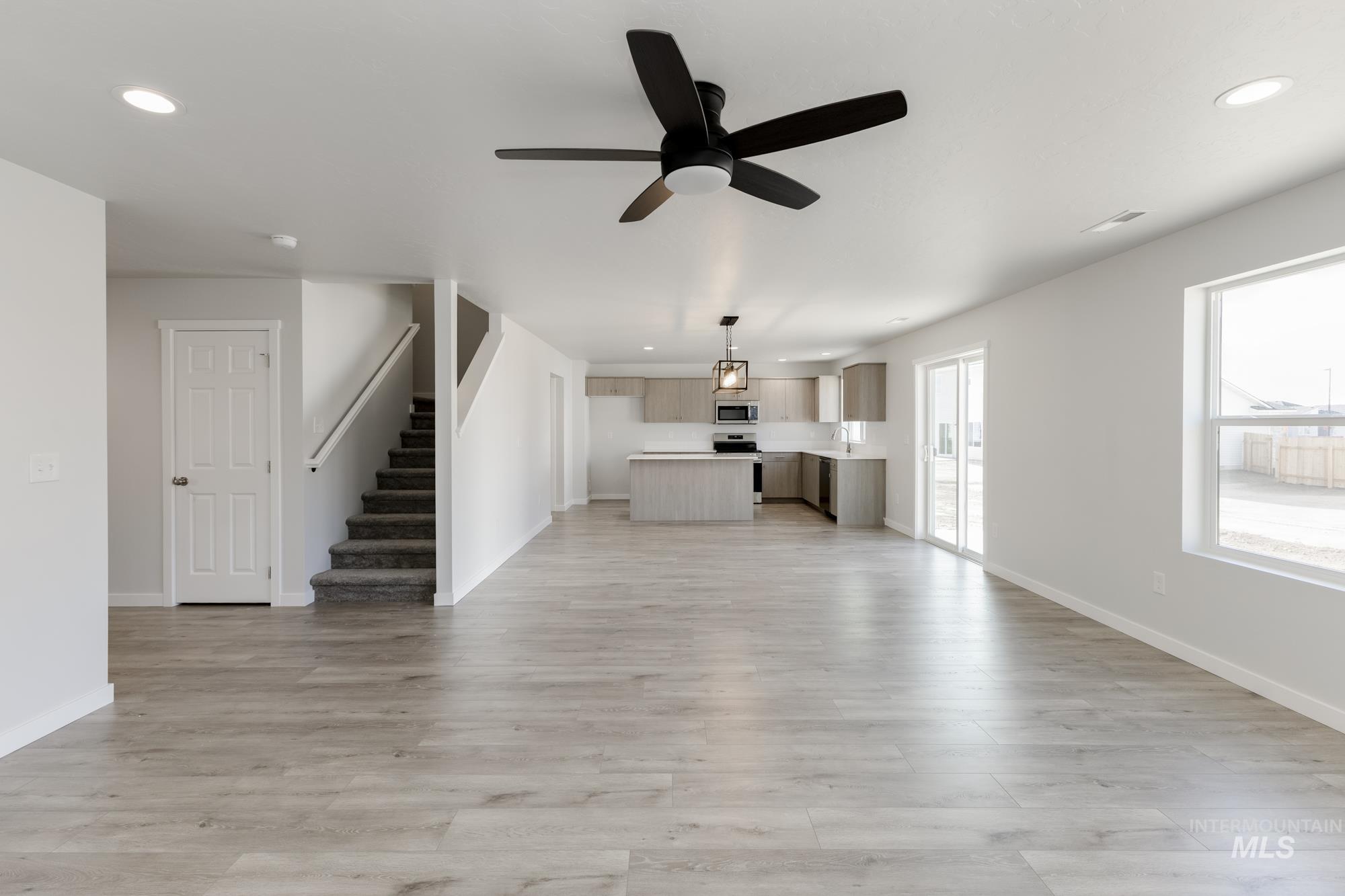 1107 Webb Brk Street Middleton, ID 83644 - Photo 10 of 23 Unfurnished living room featuring recessed lighting, ceiling fan, light wood-type flooring, and stairs