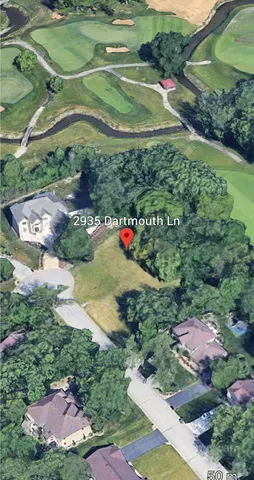 a view of a grassy field with an trees