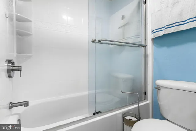 a bathroom with a shower and toilet