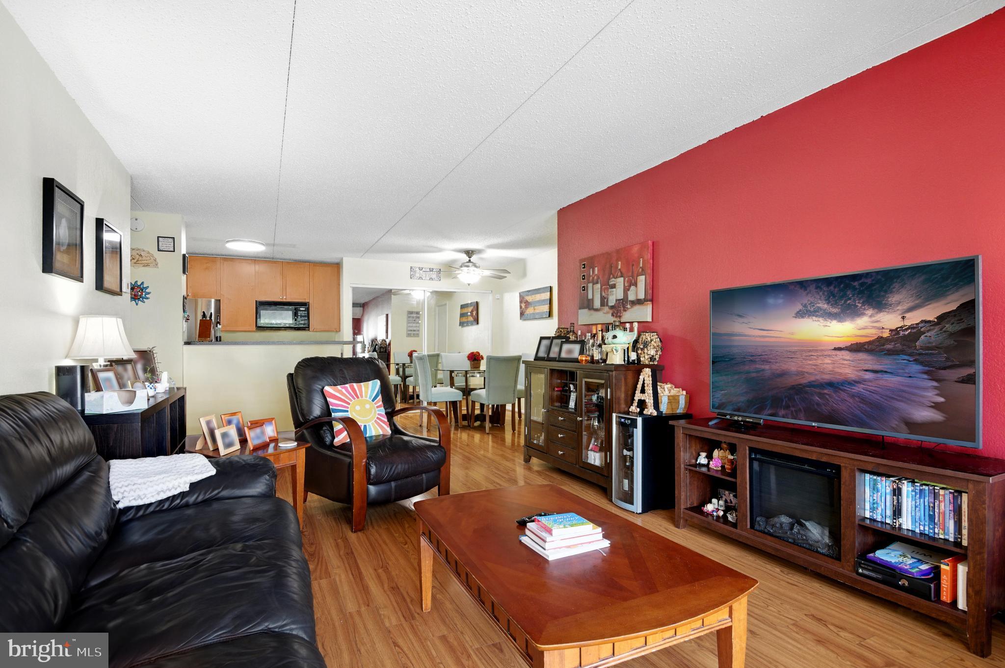 75 South Reynolds Street, Unit 101 Alexandria, VA 22304 - Photo 2 of 38 a living room with furniture and a flat screen tv