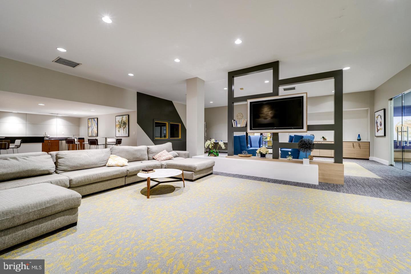 75 South Reynolds Street, Unit 101 Alexandria, VA 22304 - Photo 23 of 42 a living room with furniture and a flat screen tv