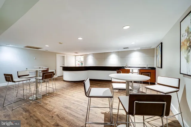 a kitchen with stainless steel appliances kitchen island granite countertop a stove a sink and a refrigerator