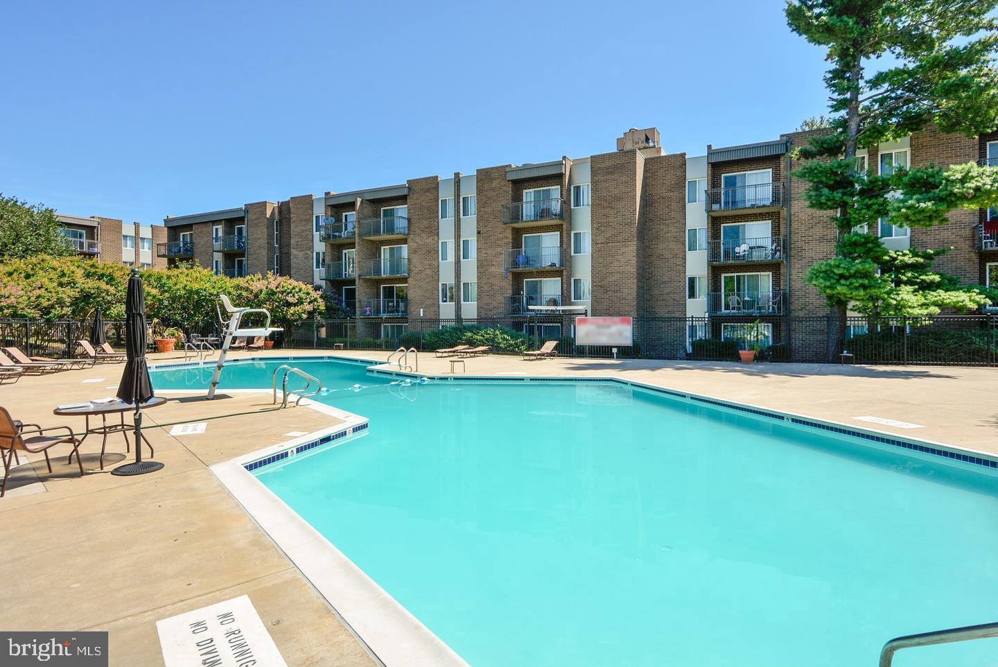 75 South Reynolds Street, Unit 101 Alexandria, VA 22304 - Photo 31 of 38 a view of swimming pool with outdoor seating and yard