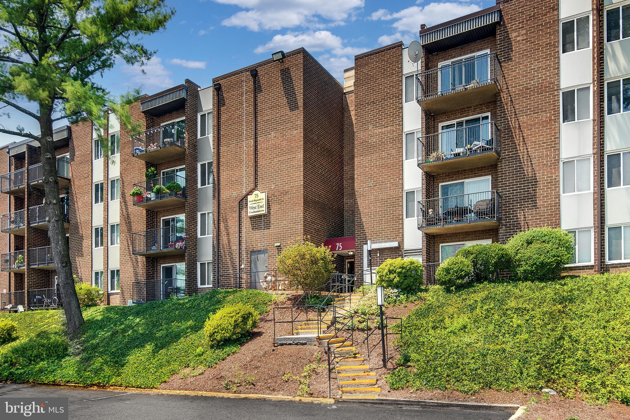 75 South Reynolds Street, Unit 101 Alexandria, VA 22304 - Photo 33 of 38 a view of a brick building next to a yard
